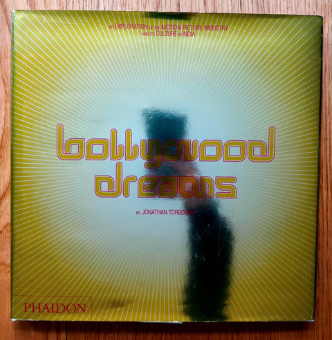 The photography book cover of Bollywood Dreams by Jonathan Torgovnik. Hardback with yellow shiny cover. Signed.
