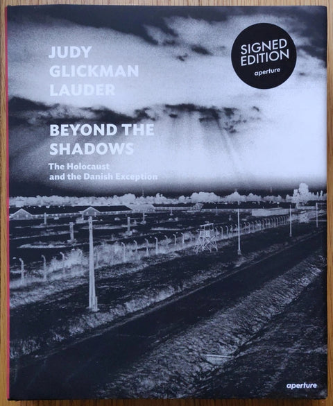 The photography book cover of Beyond the Shadows: The Holocaust and the Danish Exception. Hardback in black and white.