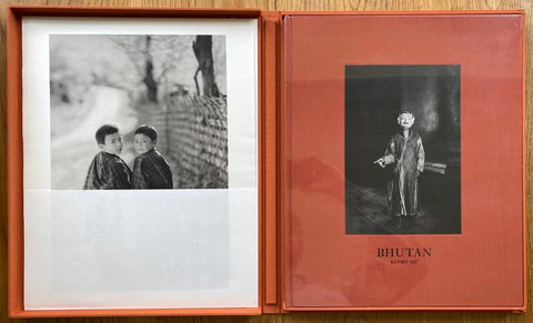 The photography book cover of Bhutan: The Sacred Within by Kenro Izu. Hardback in burnt orange, also kept in orange clamshell box. Signed.