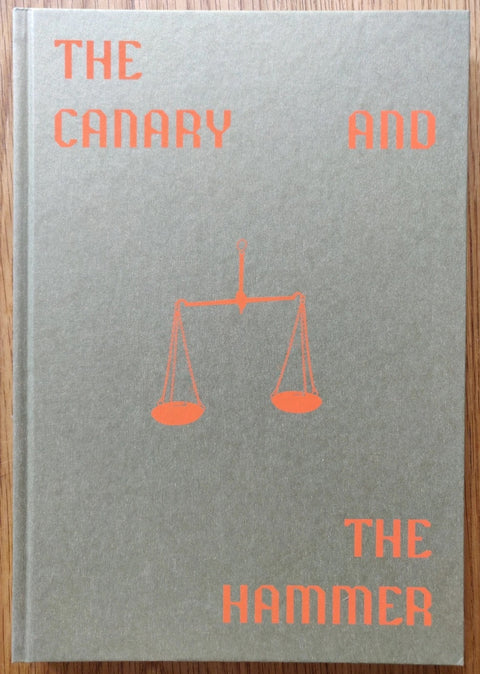 The photography book cover of The Canary and the hammer by Lisa Barnard. Hardback in grey with orange text and scales.