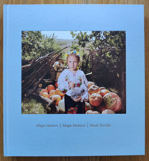 The photobook cover of Stop Tanks With Books by Mark Neville. Second edition. In hardcover baby blue.
