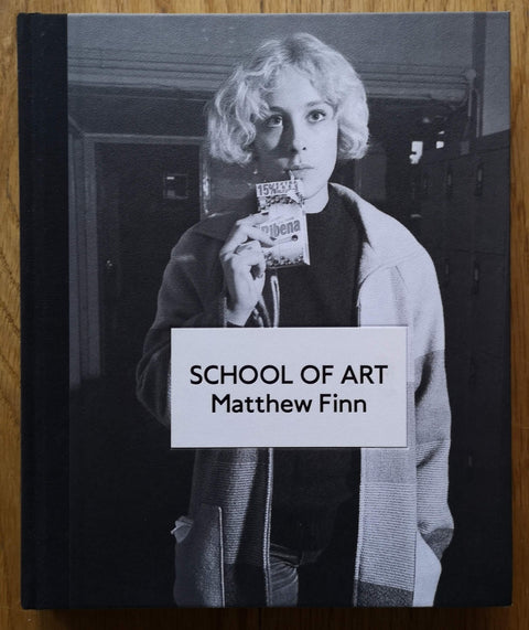 The photobook cover of School of Art by Matthew Finn. Hardback with B&W cover photo of a blonde haired girl drinking ribena. Signed.