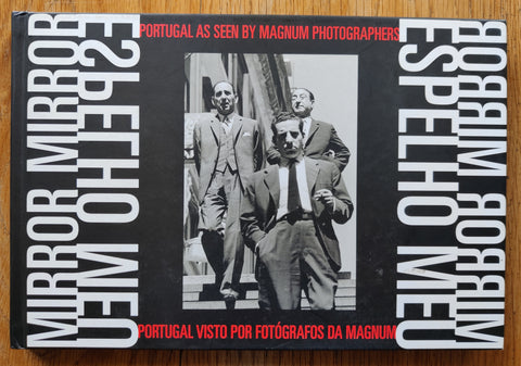 The photobook cover of Mirror, Mirror / Espelho Meu: Portugal as seen by Magnum Photographers. In hardcover black and white and red.