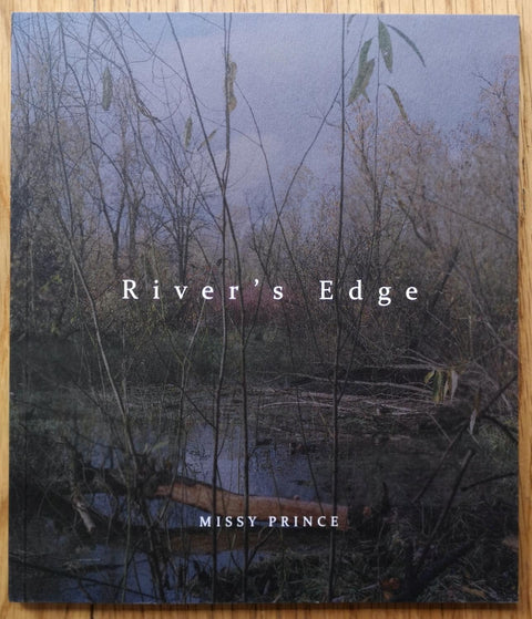 The photography book cover of River's Edge by Missy Prince. In softcover with a lake and a forest.