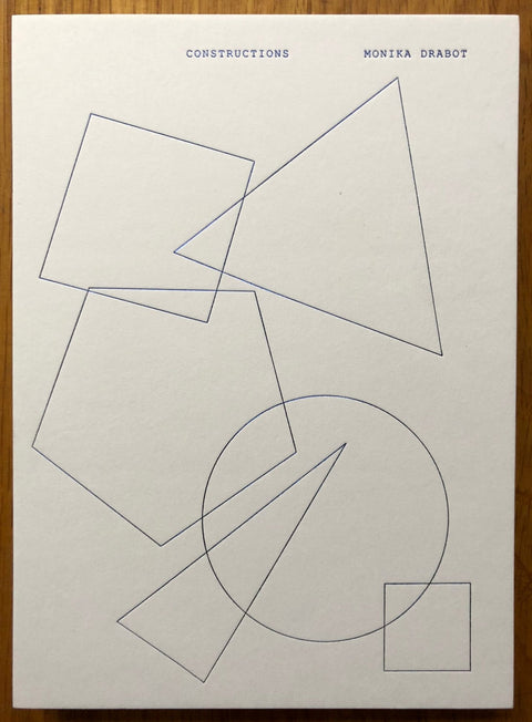 The photography book cover of Constructions by Monika Drabot. Hardback with line drawings of shapes on the cover.