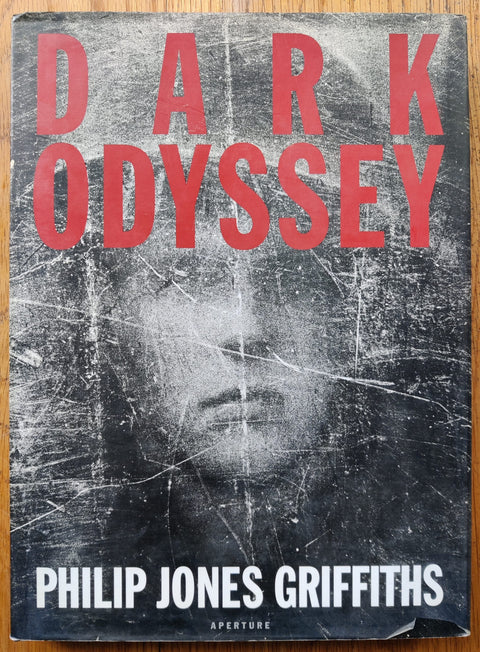 The photography book cover of Dark Odyssey by Philip Jones Griffiths. Hardback with red text title.