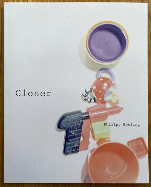 The photography book cover of Closer by Philipp Ebeling. Paperback with plastic childrens toys on the cover e.g. a toy gun. Signed.