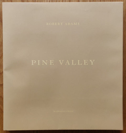 The photography book cover of Pine Valley by Robert Adams. Hardback in beige.