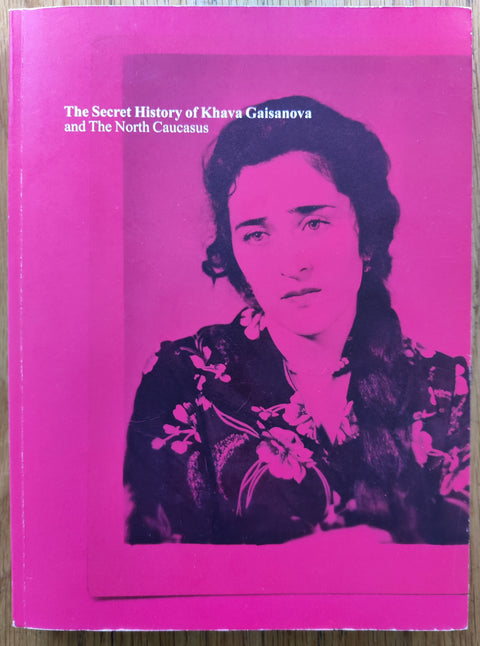 The photography book cover of The Secret History of Khava Gaisanova and The North Caucasus by Rob Hornstra. In softcover red. Signed