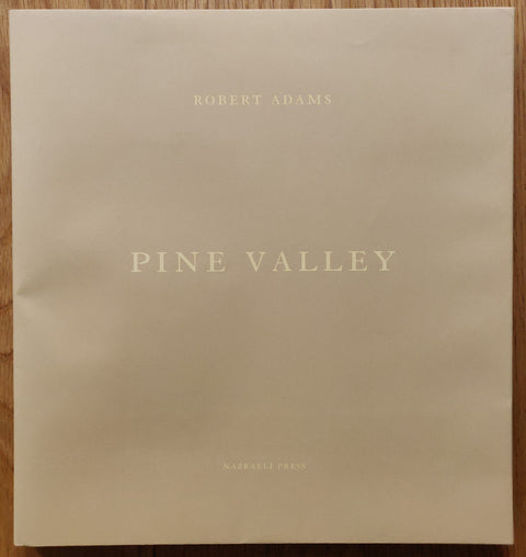 The photography book cover of Pine Valley by Robert Adams. Hardback in beige.