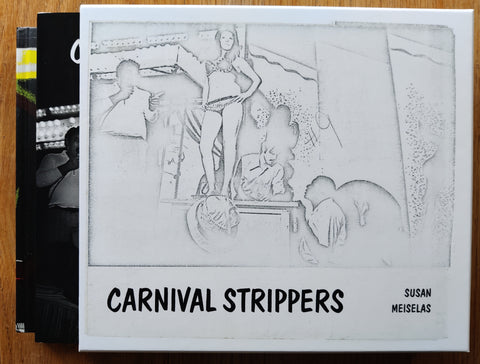 The photobook set cover of Carnival Strippers Revisited by Susan Meiselas. In hardcover slipcase in white contains to hardbacks - Carnaval Strippers and Making of.