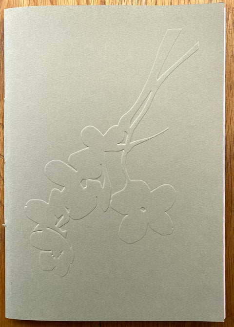 The photography book cover of Sakura by Yoshinori Mizutani. Paperback with bunch of flowers on the cover.