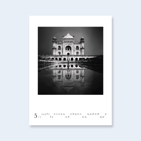 A minimalist calendar page featuring a photograph of the Taj Mahal reflected in water.