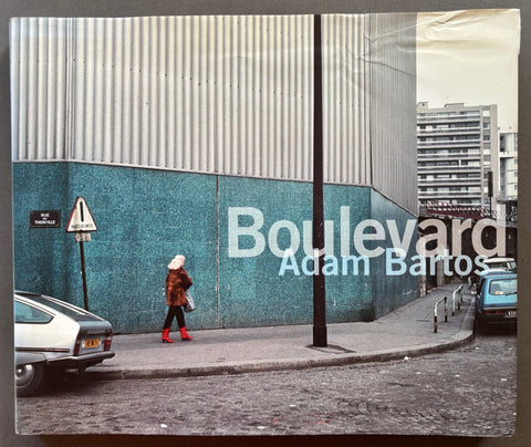 Book titled 'Boulevard' by Adam Bartos with a cover featuring an image of a woman in red boots walking along a street.