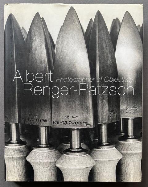 Book titled 'Photographer of Objectivity by Albert Renger- Patzsch with a cover featuring the image of several industrial tools.