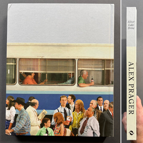 The book 'Silver Lake Drive' by Alex Prager is displayed in a clean product shot showing both the front cover and the spine. The front cover features a photograph of people standing in line outside a bus, while the spine is a warm cream color with black text.