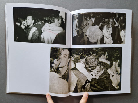 An open book, showing four black-and-white photographs printed on the pages. 