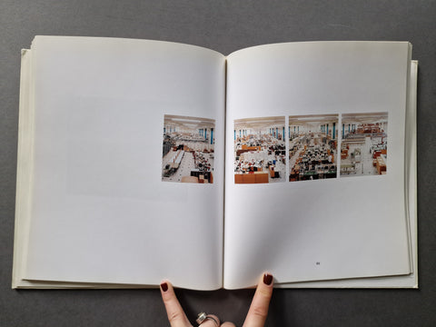 An open book, showing four interior architectural photographs printed on the pages. 