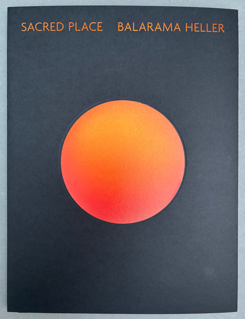 Book titled 'Sacred Place' by Balarama Heller with a black cover with an orange circle in the center.