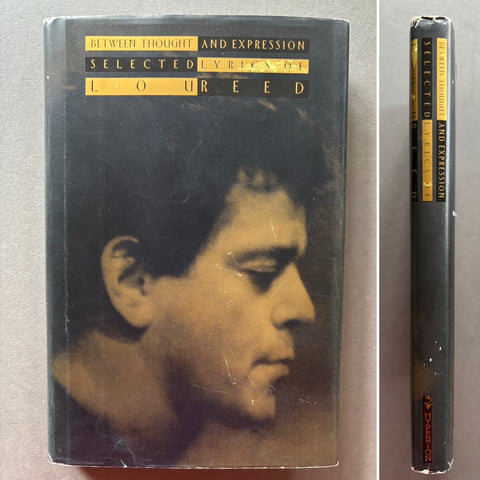 Book titled 'Between Thought and Expression: Selected Lyrics of Lou Reed' with a cover featuring a profile image of Lou Reed's face.