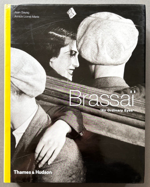 Book titled 'No Ordinary Eyes' by Brassai with a black and white cover featuring an image of a woman smiling at the man she's sitting next to.