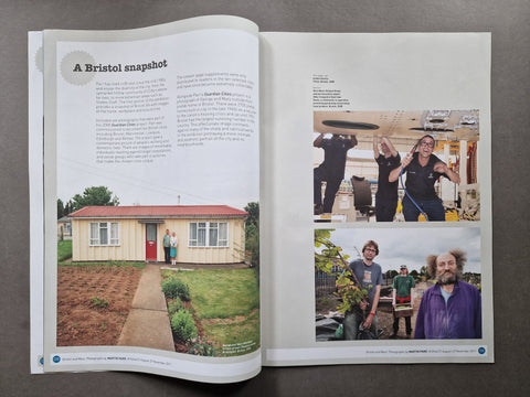 An open printed magazine spread photographed from above on a dark gray surface. The left page has the headline 'A Bristol snapshot' and a photo of a small house with a red roof and a person standing in front.