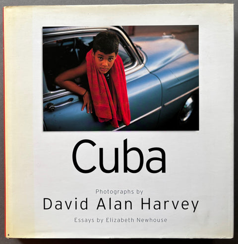Book titled 'Cuba' by David Alan Harvery with a white cover featuring the photograph of a boy leaning out of a car window.
