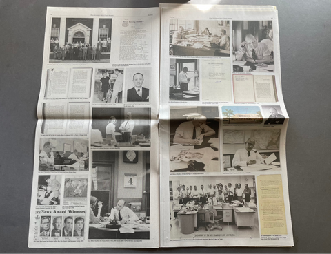 An open vintage magazine or newspaper spread laid flat on a dark gray surface, featuring multiple black-and-white photographs, columns of text, and a few small color photos.
