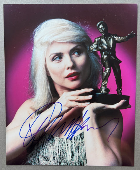 Signed print of Debbie Harry holding an award.
