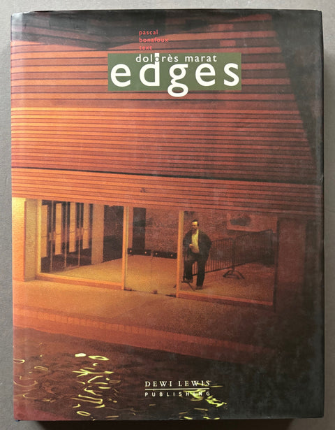 Book titled 'Edges' by Dolores Marat with a cover featuring the image of a man looking out through a window towards a swimming pool.