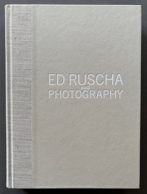 Book titled Ed Ruscha and Photography by Sylvia Wolf with a light grey cover.