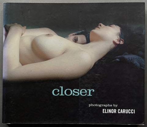Book titled 'Closer' by Elinor Carucci with a black cover featuring the image of a man and woman lying down with their bare chests revealed.