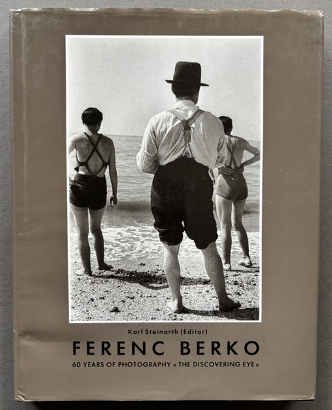 Book titled '60 Years of Photography' by Ferenc Berko with a beige cover featuring the image of the backs of some people on a beach.