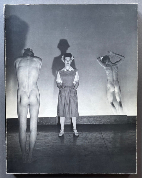Book titled 'Photographs 1931-1955' by George platt Lynes with a photographic cover featuring a woman in a nurse's uniform and the backs of 2 naked men.