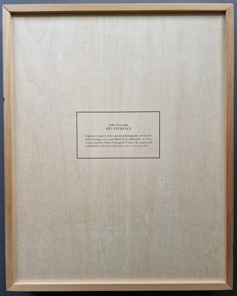 The back wood panel featuring a printed label for 'John Gossage - Hey Fuckface set against a light natural wood background.