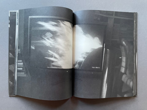Open book with black and white photographs on a gray background