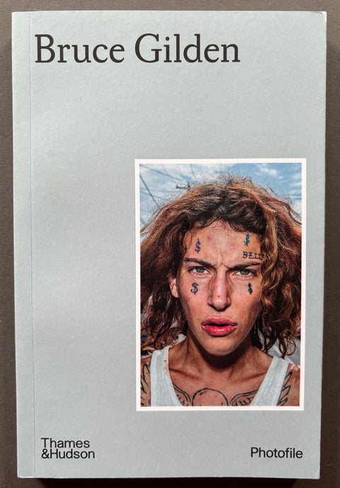 Book titled 'Bruce Gilden' with a grey cover featuring a head-shot of a young man with tattoos on his face.