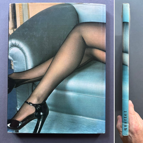 A hardcover book or magazine titled 'quartet' is shown standing upright next to its spine, with a hand holding the spine. The cover features a photograph of a person's legs wearing sheer black tights and black high heels, seated in a light blue armchair.