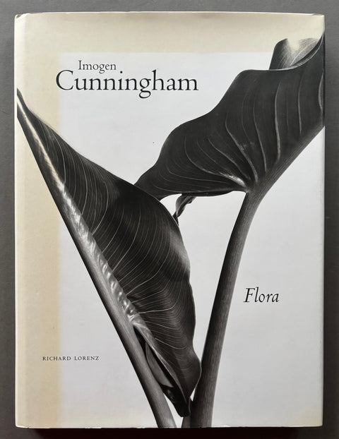 Book titled 'Flora' with a black and white cover featuring the image of two large leaves.