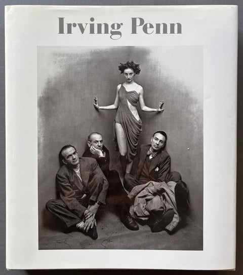 Book titled 'Irving Penn' with a white cover featuring a photograph of a woman and 3 men.