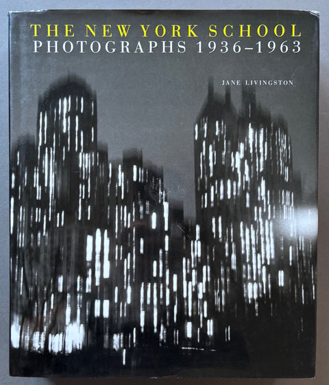 Book titled 'The New York School Photographs 1936-1963' by Jane Livingston with a cover featuring a black and white image of buildings.