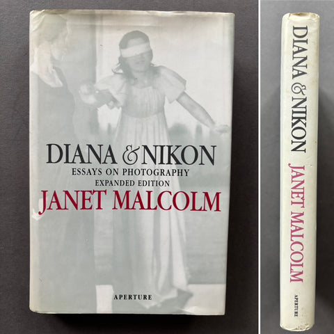 Book titled 'Diana & Nikon: Essays on Photography - Expanded Edition' by Janet Malcolm with a cover featuring an image of a blindfolded girl.
