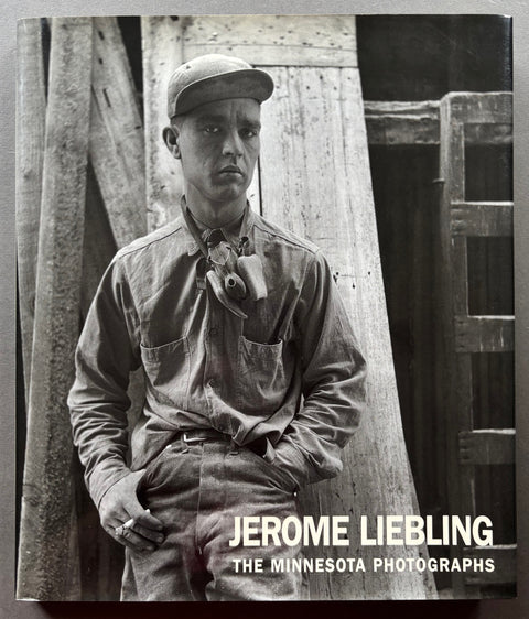 Book titled 'The Minnesota Photographs' by Jerome Liebling with a black and white cover featuring the image of a man leaning against a wooden structure.