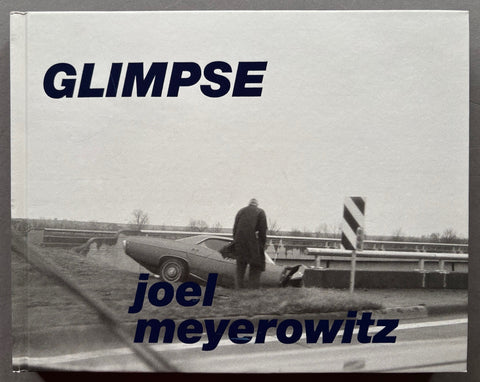 Book titled 'Glimpse' by Joel Meyerowitz with a cover featuring the image of a man standing in front of a crashed car.