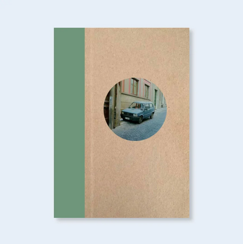 Book titled Italian Cars' by John Divola with a beige and green cover featuring a photograph of an Italian car.