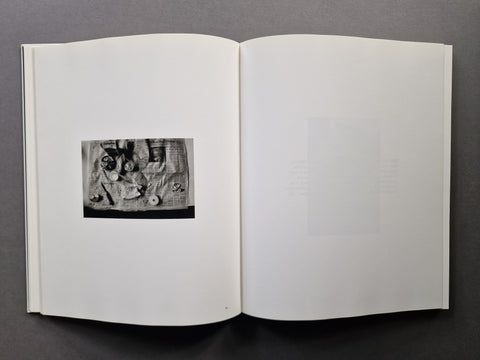 An open book spread showing a small photo of lunch on newspaper on the left.