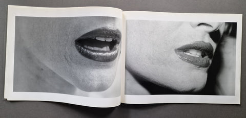An open book showing two black and white photographs of a close up of a woman's mouth.