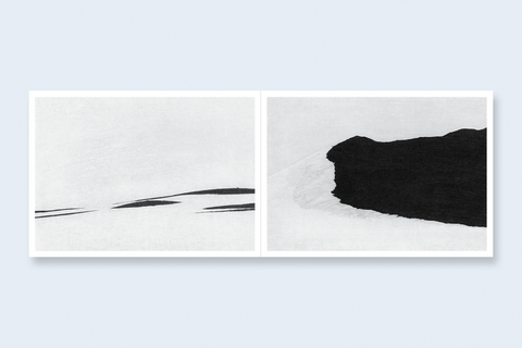 An open book spread featuring two abstract black and white landscapes.