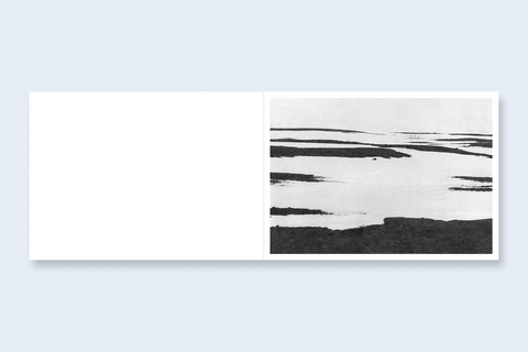 An open book spread featuring an abstract landscape on the right.