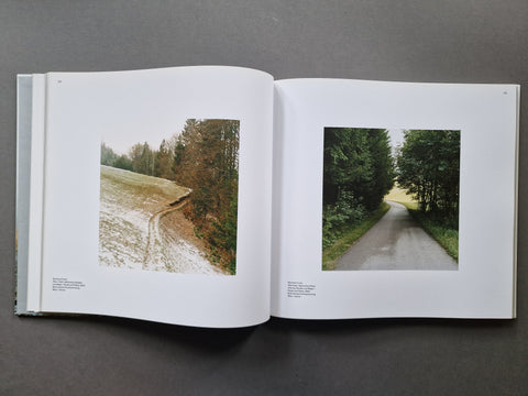An open book spread showing two photographs of forest landscapes
